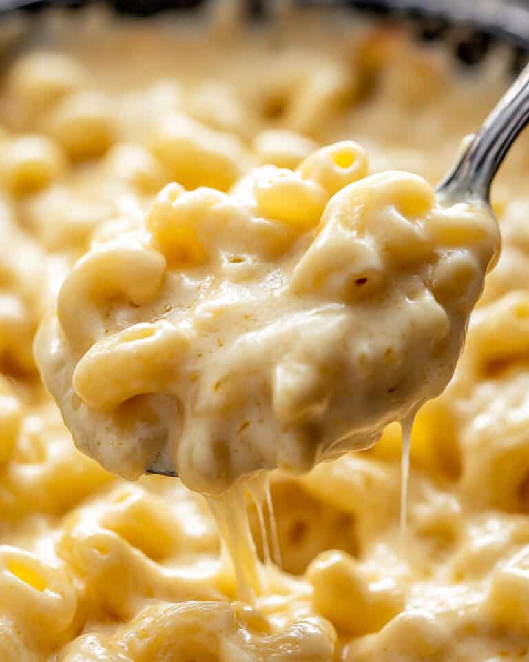 Creamy mac and cheese close-up, cheesy comfort food in a spoonful.